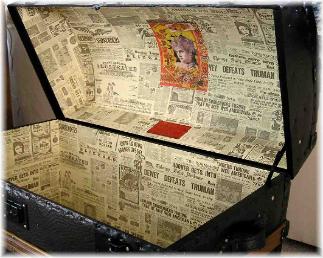 dome top with embossed pebble pattern tin, before and after pictures,  new 2 color  paint on embossed tin, refinished slats, new  leather, &  newspaper pattern lining.

This beautiful dome top trunk along with  a flat top ( not pictured) is on display in San Diego, California  as part of a  City History exhibit.